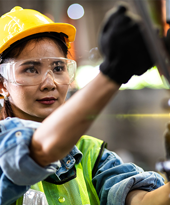 Female engineer working on machine